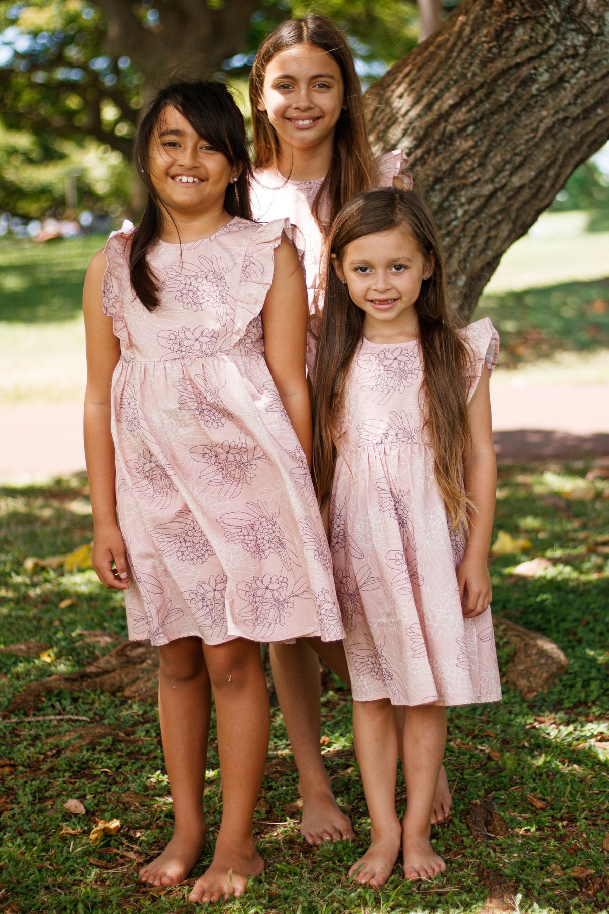 Girls Dress Maila in Opal Pink Pua Melia — Front View On-Model | Kahulaleʻa