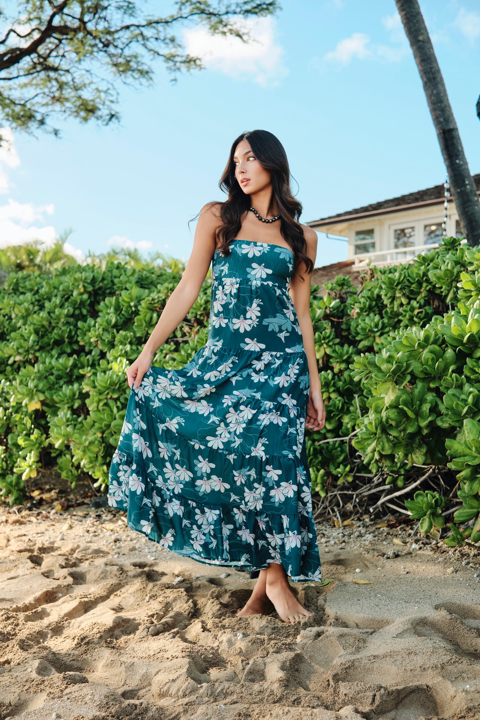 Front view of model in Tiered Maxi Noenoe in Emerald Naupaka print by Kahulaleʻa 