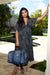 Female model holding a Duffel Bag in the Midnight Liko print by Kahulaleʻa